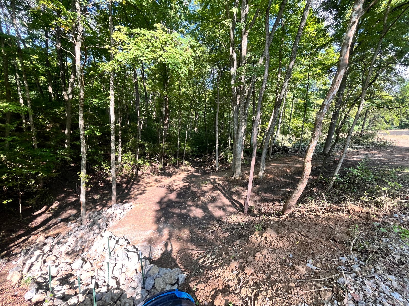 Cleared site with boulder retaining wall